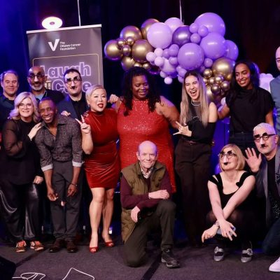 Participants and organizers of Laugh for the Cure take to the stage together to close out an entertaining evening. Photo by Caroline Phillips